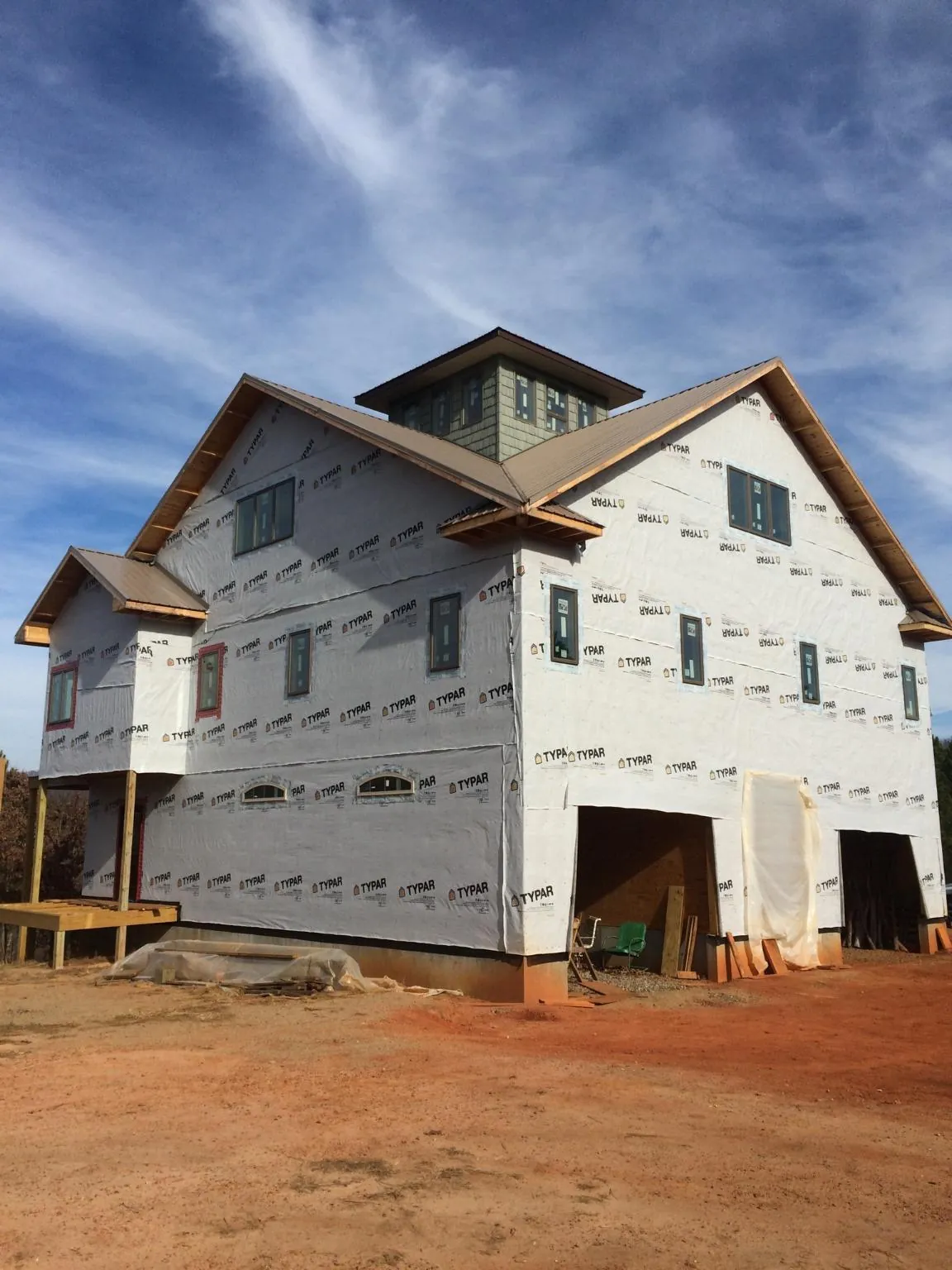 New two story house under construction with a cupola and gabled roofs in Diamondhead